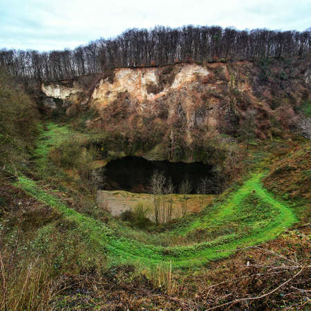 Lake and rock cliff at historic quarry site on Mount Weilberg in the Siebengebirge.の写真素材
