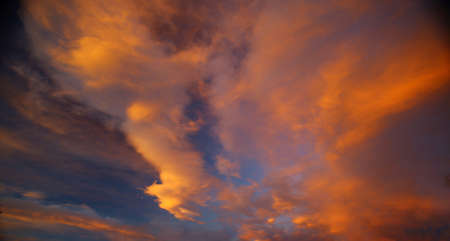 Beautiful orange cumulus cloudscape in the evening.の写真素材