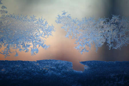 Close up of window frost and snow on a pane.の写真素材