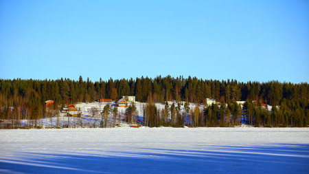 View over lake Stor-Kvammarn in Sweden with rural houses.の写真素材