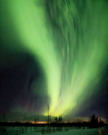 Strong green aurora band coming from the north.の写真素材