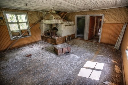 Ruined interior of an old wooden house with rusty stoves.の写真素材
