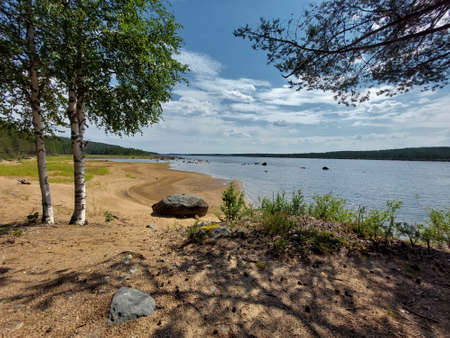 View over scenic natural beach at Skellefte river in northern Sweden.の写真素材