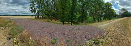 Panorama of small road ending in gravel and dirt road.の写真素材