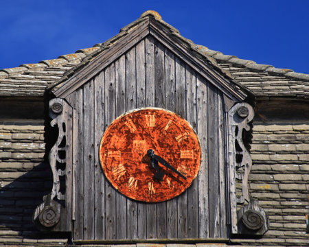 Rusty turret clock on a sunny day.