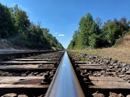 Looking closely over a straight rural railway track.の写真素材