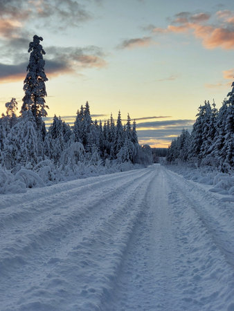 Grooves in the snow in front of beautiful winter evening sky.の写真素材