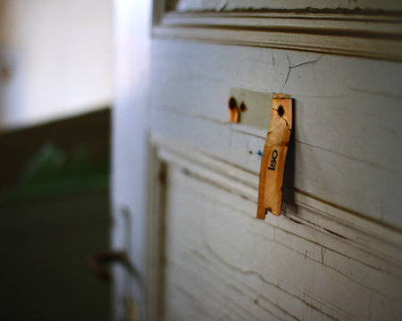 Torn sign at the door of an abandoned quarantine station, Iso (abbreviation for Isolation) is...