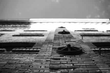 Upward view on facade of old factory building, black and white image.の写真素材