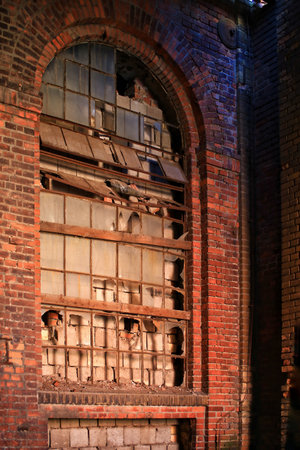 Big, broken and walled window in an old factory building.の写真素材