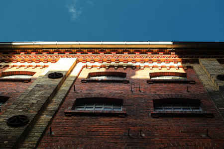 Upward view on facade of old factory building.の写真素材