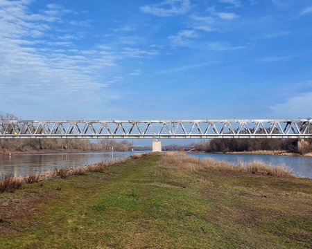 Steel frame railway bridge over the Elbe River on a sunny winter day.の写真素材