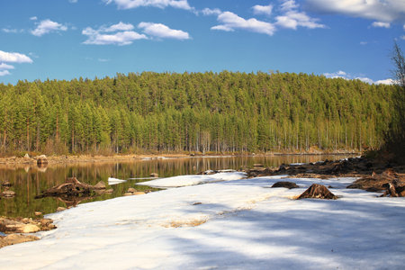 Big ice floe on the shady side of a river in Sweden.の写真素材