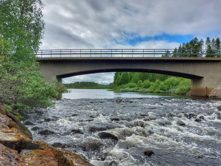 Bridge over rapids in a northern Swedish river.の写真素材