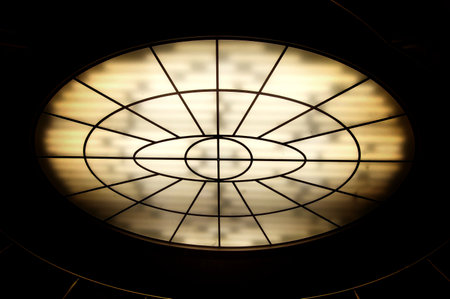 Conceptual high contrast shot of oval lighting at the ceiling.の写真素材