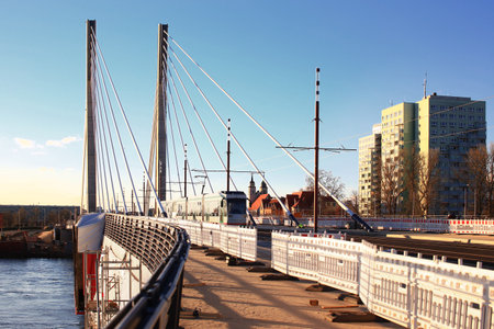 New bridge spans Elbe river in Magdeburg with a tram crossing it.の写真素材
