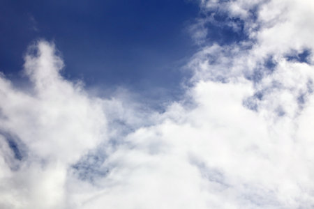 Cumulus clouds background with vibrant blue sky.の写真素材