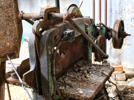 Rusted industrial equipment showing severe decay and corrosion inside an abandoned factory site.
