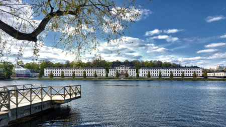 Broad waterfront scene showing Karlbergs palace in Stockholm and dock under a clear blue spring sky.の写真素材