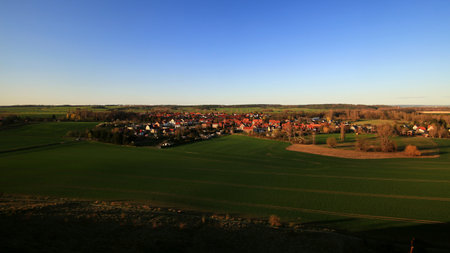 Village Weddersleben amid fields viewed from elevation in the evening near the Teufelsmauer, Harz mountains.の写真素材