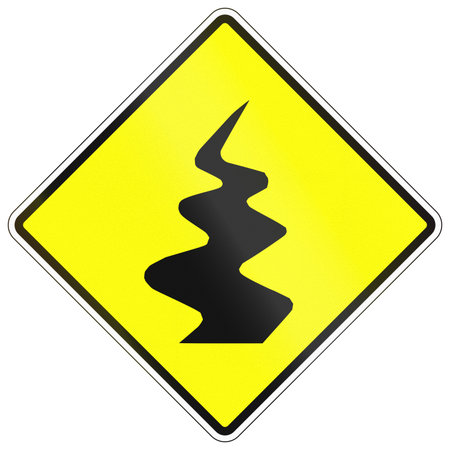 Warning road sign in Cambodia - Winding road.の写真素材