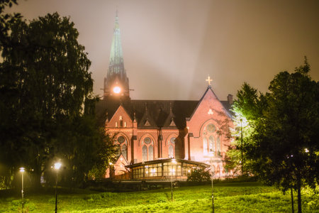 Umea stadskyrka (Umea city church) glowing at night with mist and lights in northern Sweden.の写真素材