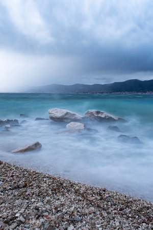 Beautiful seascape with pebble beach and cloudy skyの写真素材