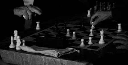 Chess game. Close-up of a man playing chess. Black and white photo.の写真素材