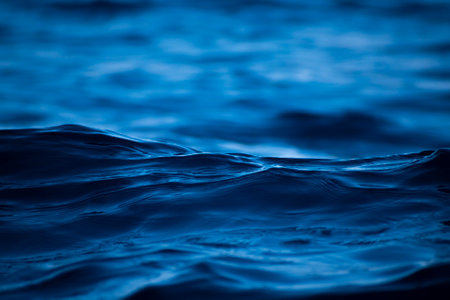 Blue water surface background. Close up of water surface with ripplesの写真素材