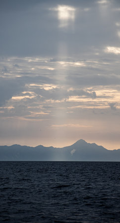 sunset over the sea and mountains in the background, photo as a background, digital imageの写真素材