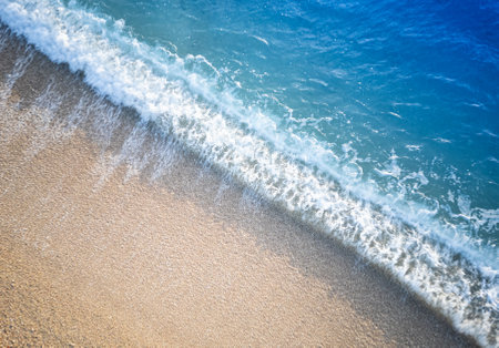 Wave of the sea on the sandy beach. Summer vacation background.の写真素材