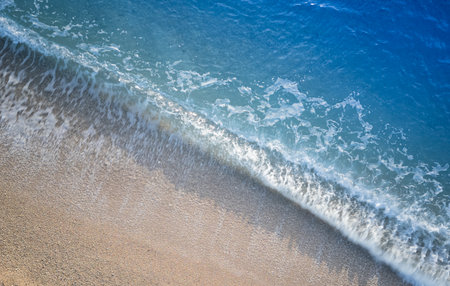 beautiful sandy beach and sea wave close-up. summer backgroundの写真素材