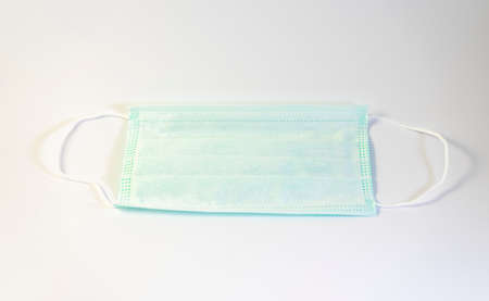 Medical mask of green color for protection against flu and other diseases.