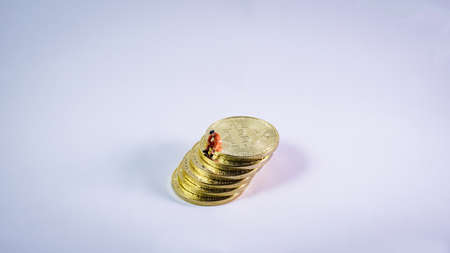 Bitcoin mining miniature Sit and rest on Bitcoin with white background