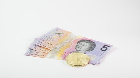 Background with Bitcoin cryptocurrency coins and Australian Dollar dollar. Bitcoin cryptocurrency...