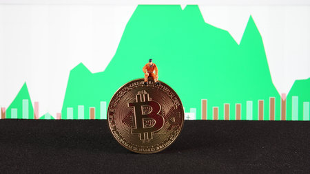 A mining miniature is Investment failure from bitcoin trading on stock background. conceptual image for investment of cryptocurrency.の写真素材