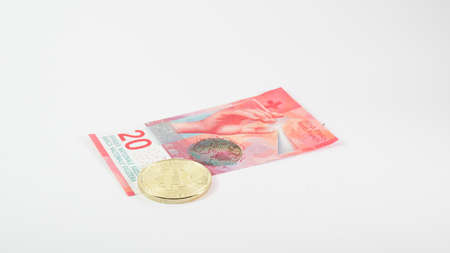 Background with Bitcoin cryptocurrency coins and Swiss franc dollar. Bitcoin cryptocurrency concept, Bitcoin BTC virtual money and Swiss franc dollar banknotes.の写真素材
