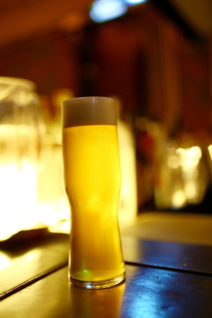 A glass of beer on the barの写真素材