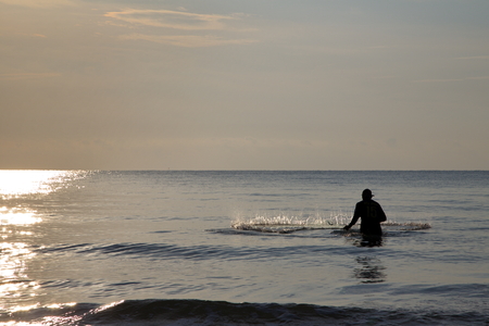Fisherman is throwing the net in the seaの写真素材