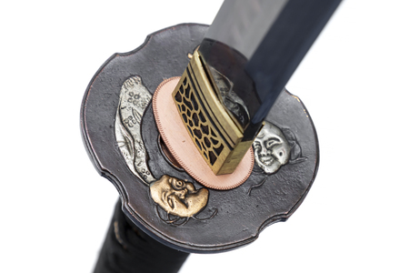 Devil Tsuba : handguard of Japanese sword made of copper isolated in white background.