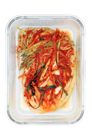 Kimchi cabbage in a glass rectangular bowl isolated in white background, top view, Korean food, copy space on right. Selective focus.の写真素材