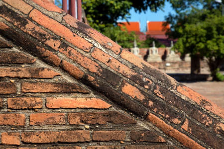 Brick railing of a temple in Thailand With a blur background of the temple area On a sunny dayの写真素材