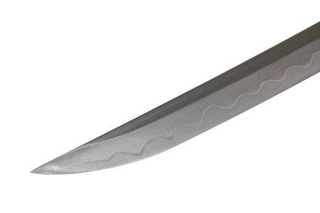 Japanese sword blade on white background. Soft focus.  The wavy pattern on the blade edge is a line of hardness that a blacksmith makes so that the blade doesn't break.  Each piece is unique.の写真素材