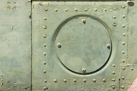 The exterior wall surface of the military helicopter is very old military green paint peeling off. in the bright sunlight during the dayの写真素材