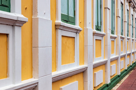 Bangkok,Thailand - April 16, 2023: The yellow building contrasts with the white stripes and has light green windows of Thailand's Ministry of Defense. A popular spot for tourists to take pictures.のeditorial素材