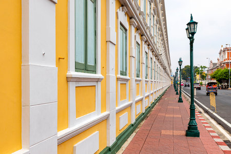 Bangkok,Thailand - April 16, 2023: The yellow building contrasts with the white stripes and has light green windows of Thailand's Ministry of Defense. A popular spot for tourists to take pictures.のeditorial素材