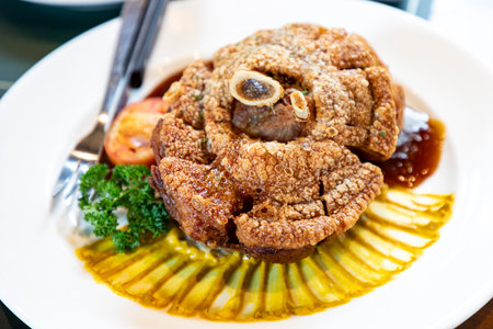 This dish of fried pork knuckle is fried until the skin is crispy and golden brown. The pork inside is soft and juicy. Fragrant scent of spices and herbs Meticulously seasoned, definitely delicious.の写真素材