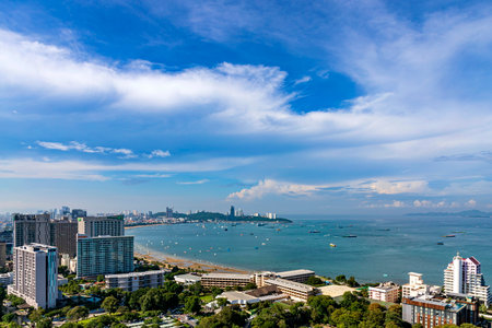 Chonburi, Thailand - 26 Oct. 2023; Morning view of Pattaya sea Saw many accommodations, both tall and low-rise buildings. There are many trees. Sea level has receded until you can see a sandy beach.のeditorial素材