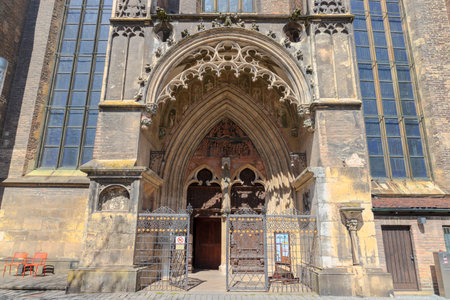 HDR image of Ulm Minster, the tallest church in the world, showcasing Gothic details under a clear blue sky on a sunny day. Perfect for travel, architecture, historical and inspiring design projects.の写真素材