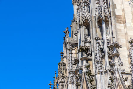 HDR image of Ulm Minster, the tallest church in the world, showcasing Gothic details under a clear blue sky on a sunny day. Perfect for travel, architecture, historical and inspiring design projects.の写真素材